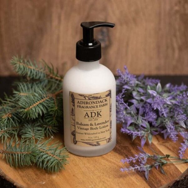 Balsam Lavender Body Lotion with ADK label on a wooden background with botanicals