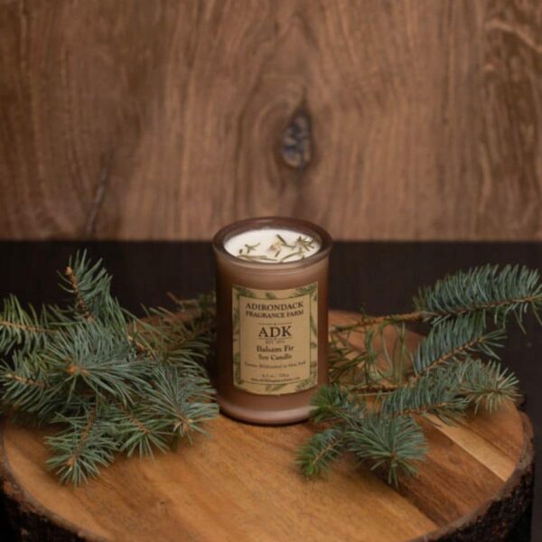 Balsam Fir Candle with an ADK Label on a wooden plate