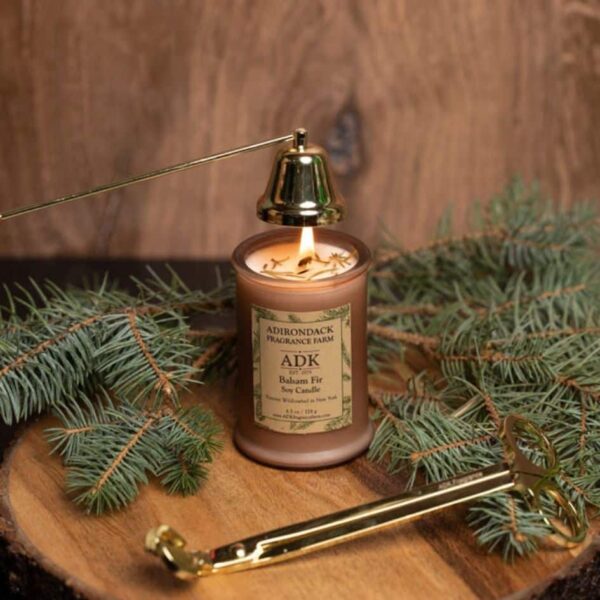 Balsam Fir Candle with an ADK Label on a wooden plate with wick snuffer and trimmer