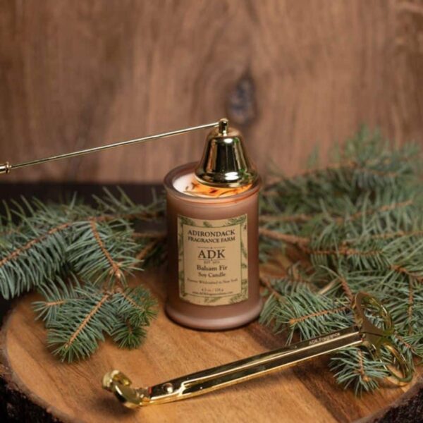 Balsam Fir Candle with an ADK Label on a wooden plate with wick snuffer and trimmer