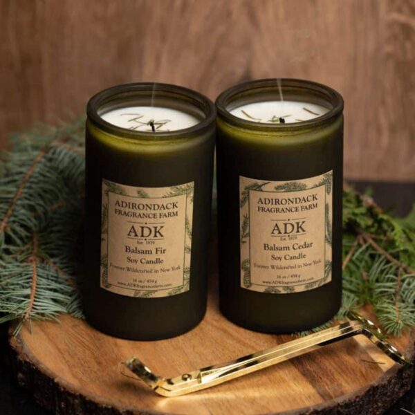 Balsam Fir Candle with Balsam Cedar Candle16oz with ADK Label on a wooden plate with wick snuffer and wick trimmer