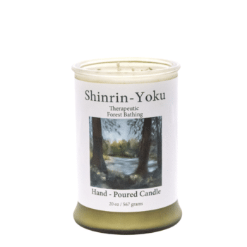 White frosted glass with white label. Photo of the ADK Forest. Shinrin Yoku 20oz candle.