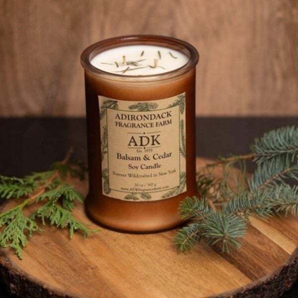 Balsam Cedar Candle with ADK label 20oz on a wooden plate