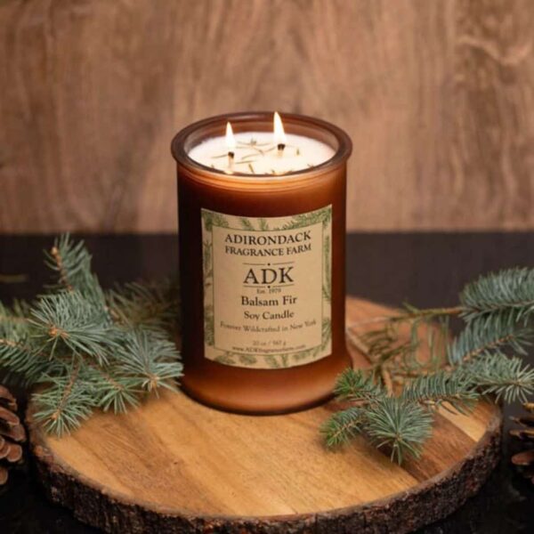 Balsam Fir Candle with an ADK Label on a wooden plate. 20oz