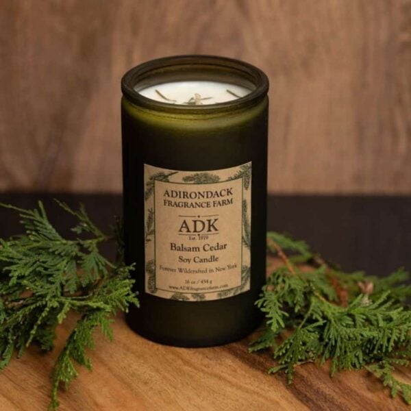 Balsam Cedar Candle 16oz with ADK Label on a wooden plate